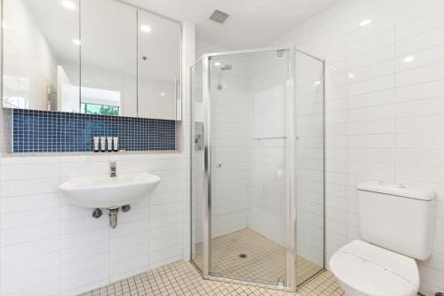 a bathroom with a shower and a toilet and a sink at Belle Escapes - Sea the Views in Glenelg