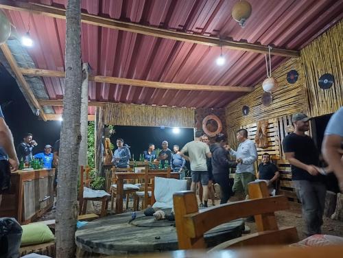 a group of people standing around in a restaurant at El Pajas in Puerto Velasco Ibarra