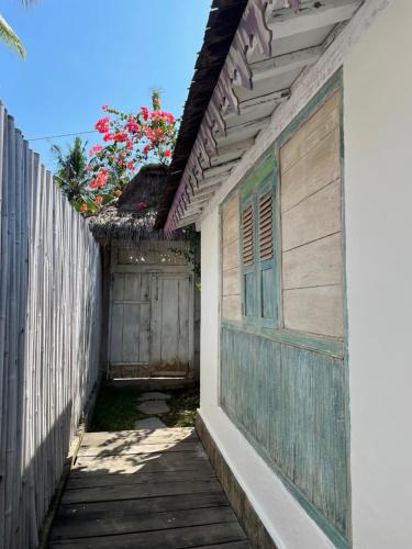 a wooden walkway next to a wooden fence at Captain Coconuts Gili Air in Gili Air