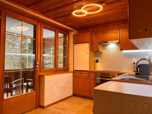 a kitchen with wooden cabinets and a counter top at Peacefull Mountains View in Kandersteg
