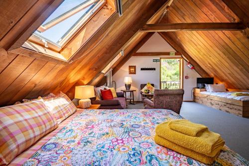 a bedroom with a large bed in a attic at French Peak Loft - French Farm Holiday Home in Akaroa