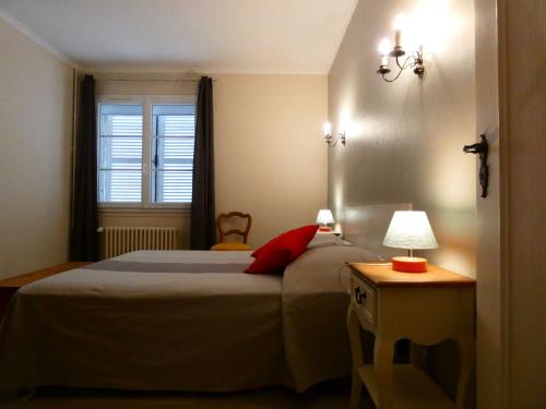 a bedroom with a large bed and a window at Maison en pierre rénovée, 3 chambres, jardin clos, équipée, calme et proche étang à Senonches - FR-1-581-36 in Senonches