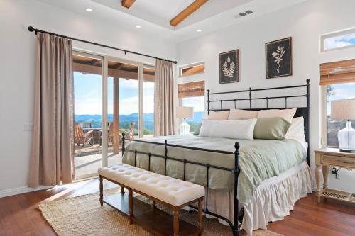 a bedroom with a bed and a large window at Private Ranch Retreat in Lompoc