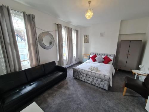 a living room with a bed and a couch at 3-Bed House in London self-contained in Ladywell in London