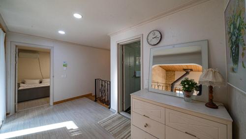 a room with a mirror and a clock on the wall at Amuse 545 in Yangpyeong