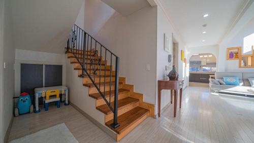a living room with a staircase in a house at Amuse 545 in Yangpyeong