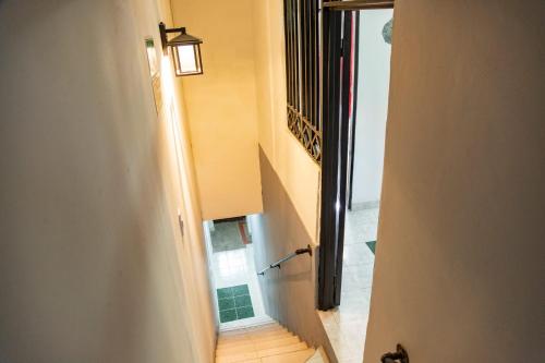 a hallway with a stairway with a light on it at Coliving7 Aparta Hotel & Habitaciones in Ibagué