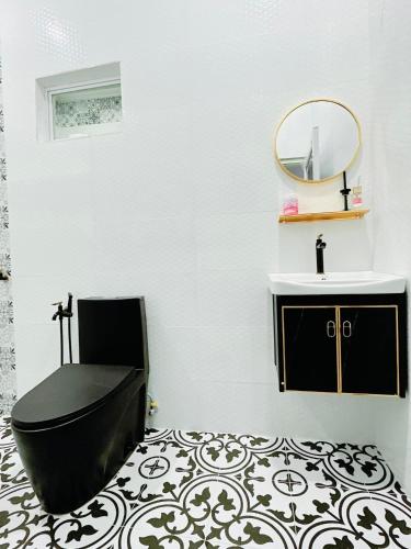 a bathroom with a sink and a toilet and a mirror at TeratakAyahBonda in Kuala Terengganu