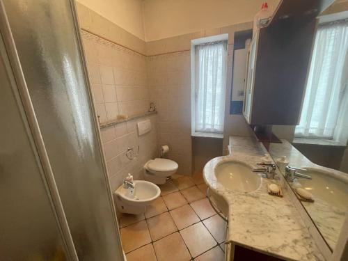 a bathroom with a sink and a toilet and a tub at Bilocale elegante a Pragelato in Pragelato