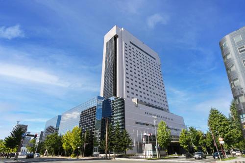 a tall building with many windows in a city at Grand Mercure Sapporo Odori Park in Sapporo