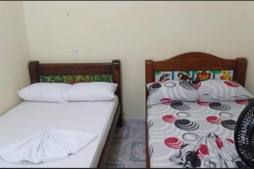 two twin beds in a room withskirts at Casa en Doradal - Antioquia in Doradal