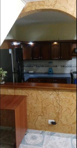 a kitchen with wooden cabinets and a counter top at Casa en Doradal - Antioquia in Doradal