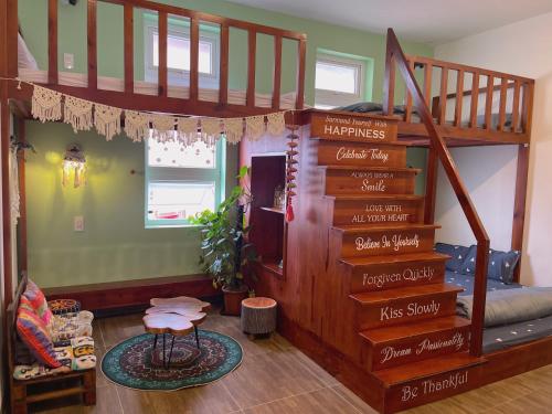 a room with a loft bed with stairs with words on it at Selena Dalat Homestay in Da Lat