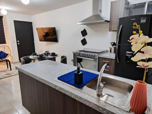 a kitchen with a sink and a refrigerator at Departamento para 7 Personas 3 Recamaras Equipado in Buena Vista