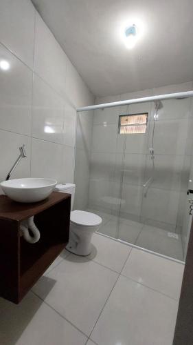 a bathroom with a shower and a toilet and a sink at Casa 3 - Estrela Dalva, vista para o mar! in Farol de Santa Marta