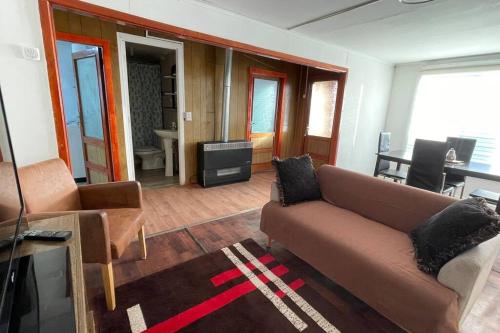 sala de estar con sofá y TV en Casa en arriendo muy amplia con dos habitaciones en Punta Arenas