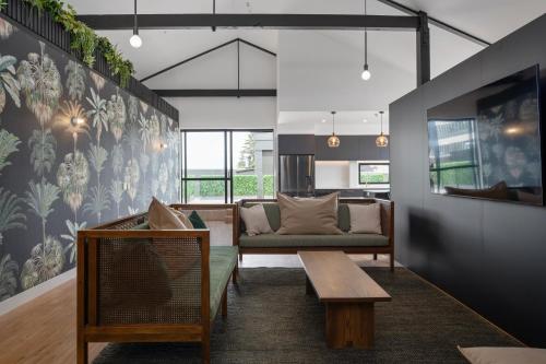 a living room with a couch and a table at The Chamberson in Dunedin