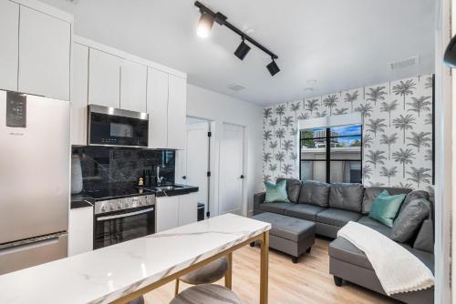 a kitchen and a living room with a couch at Lux Retreat By Renzzi in Miami