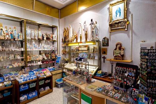 a store with a lot of figurines on display at Hôtel Saint Etienne in Lourdes