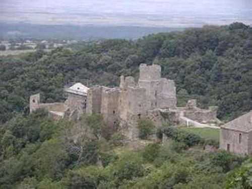 an old castle sitting on top of a hill at Chez Providence Chambres et Table d'Hôtes in Cuxac-Cabardès