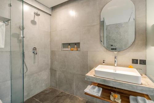 a bathroom with a sink and a shower at Kandarpa Ubud CHSE Certified in Ubud