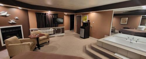 a large living room with a room with a fireplace at Inn of the Dove - Romantic Luxury Suites with Jacuzzi & Seasonal Fireplace at Harrisburg-Hershey-Philadelphia, PA in Harrisburg