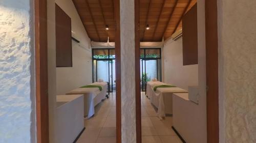 a corridor of a hospital room with four beds at EKHO Surf in Bentota