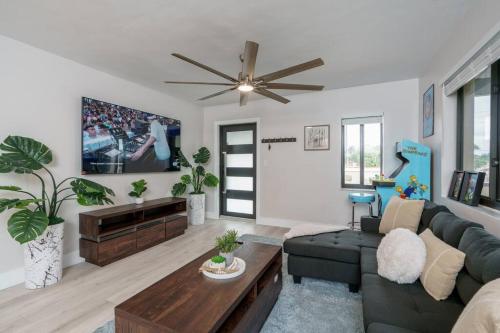 a living room with a couch and a ceiling fan at New! Miami & Calle Ocho Simpson's Funhouse! in Miami