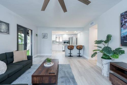 a living room with a couch and a table at New! Miami & Calle Ocho Simpson's Funhouse! in Miami
