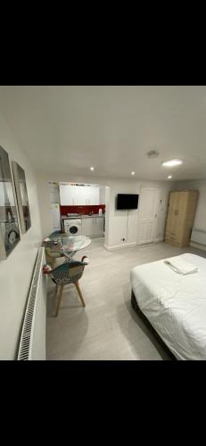 a bedroom with a bed and a table in it at St James Apartments in Leeds
