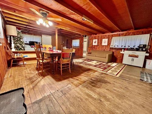 a large living room with a table and chairs at O Me, O Mio Cabin near the AuSable River in Mio