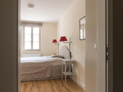 a bedroom with a bed and a window at Ferienwohnung mit Kamin im Gut Ulrichshusen in Tressow