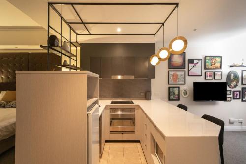 a kitchen with a white counter top in a room at CBD Executive Apartment right by the Harbour in Sydney