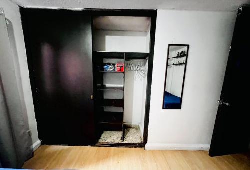 an open door to a room with a refrigerator at Habitaciones Saturno o Jupiter in Mexico City