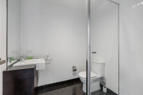 a bathroom with a toilet and a sink and a shower at 'Swanston Central' Wellness-infused City Living in Melbourne