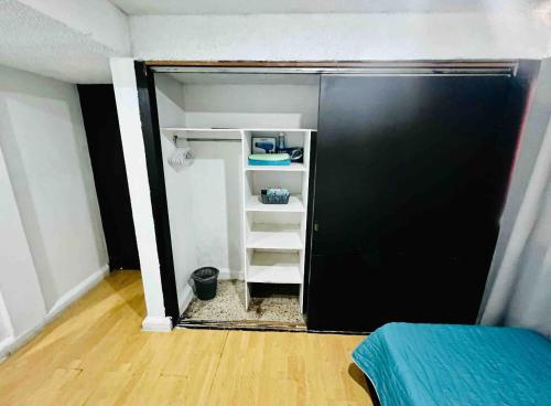 a small room with a black door and a shelf at Habitaciones Saturno o Jupiter in Mexico City