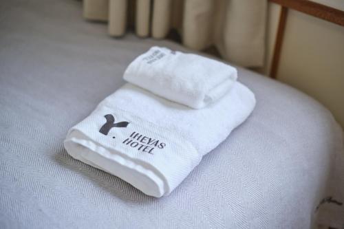 two towels sitting on top of a bed at TORA HOTEL Tokyo Ueno 寅ホテル 上野 D in Tokyo