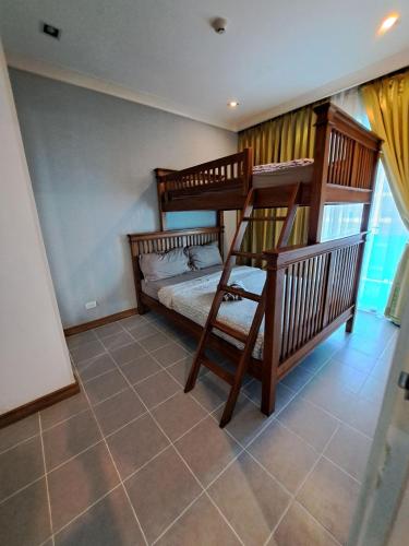a bedroom with two bunk beds and a tiled floor at My Resort Condo Hua Hin By Hua Hin Hip in Hua Hin