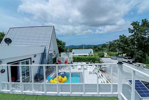 a balcony of a house with a swimming pool at The I-style pool villa in Ban Tao Than