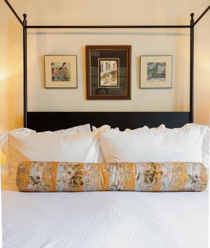 a bedroom with a bed with white pillows at Hotel Cleo, Knoxville Downtown, a Tribute Portfolio Hotel in Knoxville