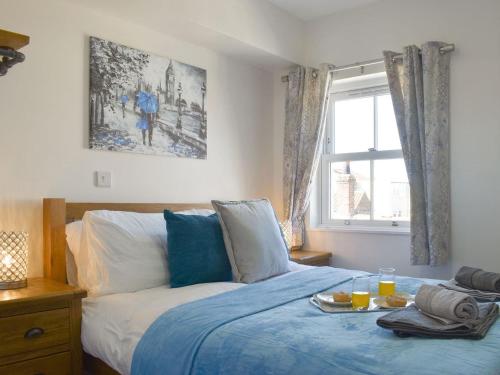a bedroom with a bed with a tray of food on it at Sir Nigel Gresley in Flamborough