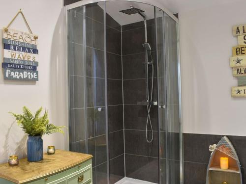 a bathroom with a shower with a glass door at Sir Nigel Gresley in Flamborough