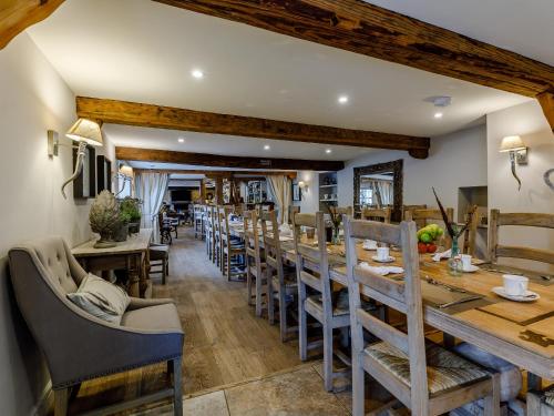 a dining room with a long table and chairs at The Grousemoor in Llandegla
