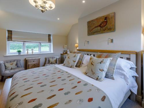 a bedroom with a large bed and a window at The Grousemoor in Llandegla