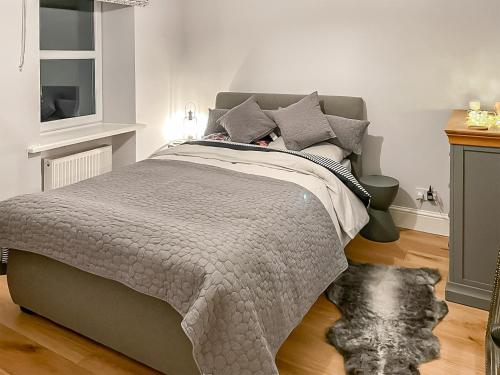 1 dormitorio con 1 cama con edredón gris en Belle Vue en High Bentham