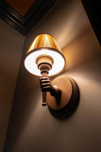 a light on a wall with a light on it at Hotel Cleo, Knoxville Downtown, a Tribute Portfolio Hotel in Knoxville