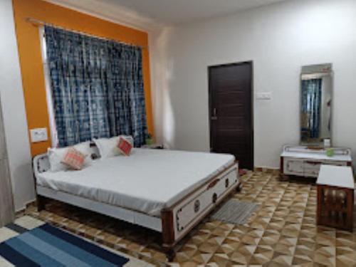 a bedroom with a large bed in a room at Mulberry Guesthouse Guwahati in Guwahati