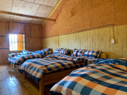 a group of four beds in a room at Hoàng nam Homestay in Quang Ba