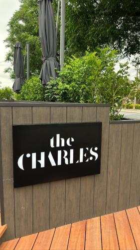 a sign on a fence with a closed umbrella at The Charles in Wagga Wagga