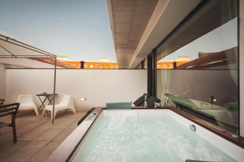 a swimming pool on the roof of a house at Urban Master in Aveiro